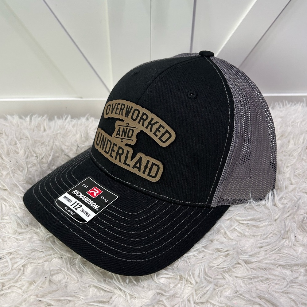 Overworked and underlaid. Trucker Richardson 112 hat.